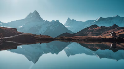 a mountain range with a lake in the foreground